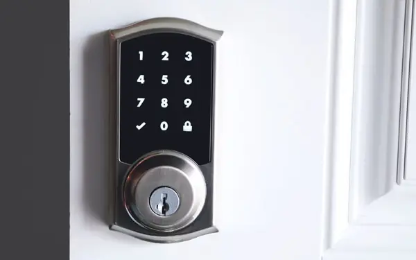 Keypad smart deadbolt on a white front door