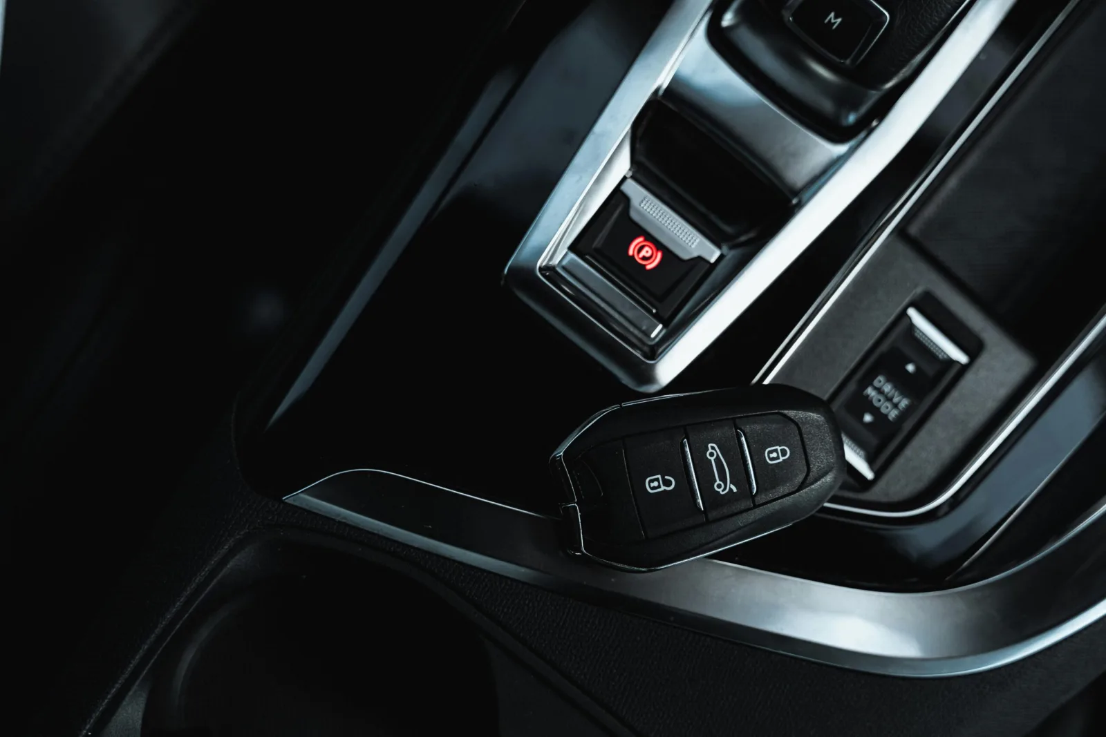 Vehicle key fob resting on a car center console