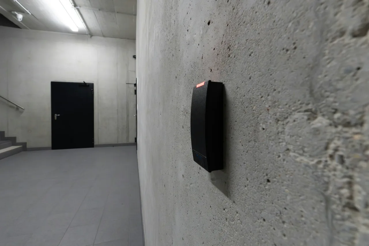 Access reader mounted beside a secured commercial door