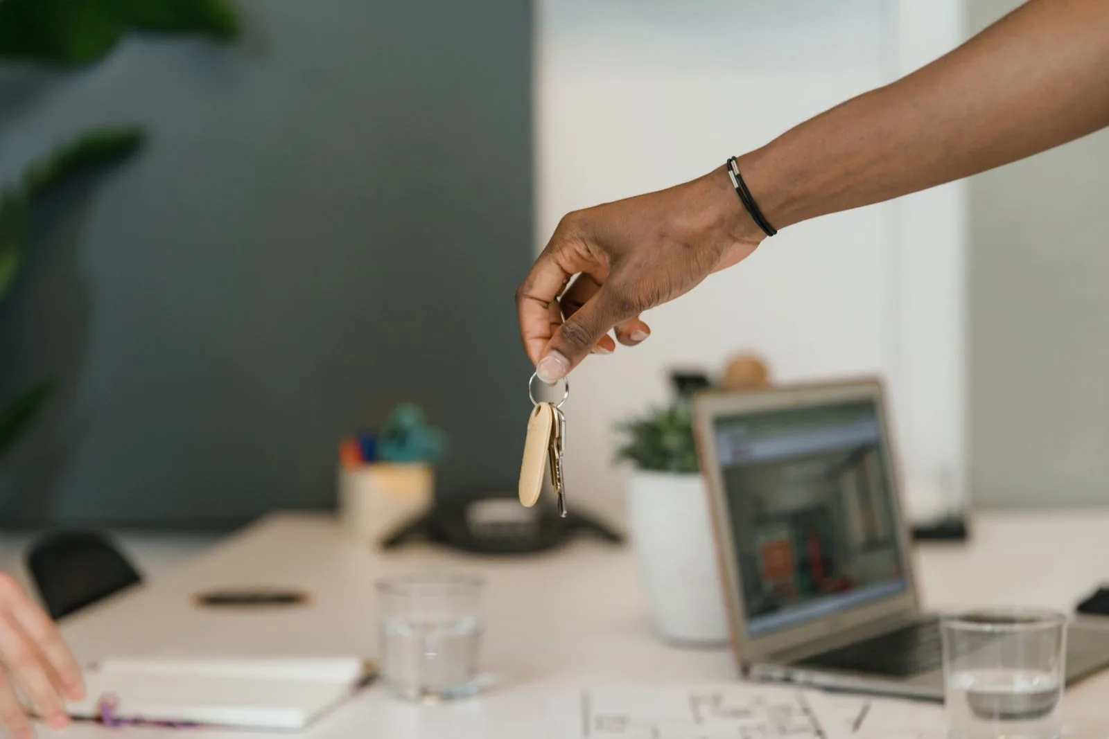Business keys being handed over at an office desk