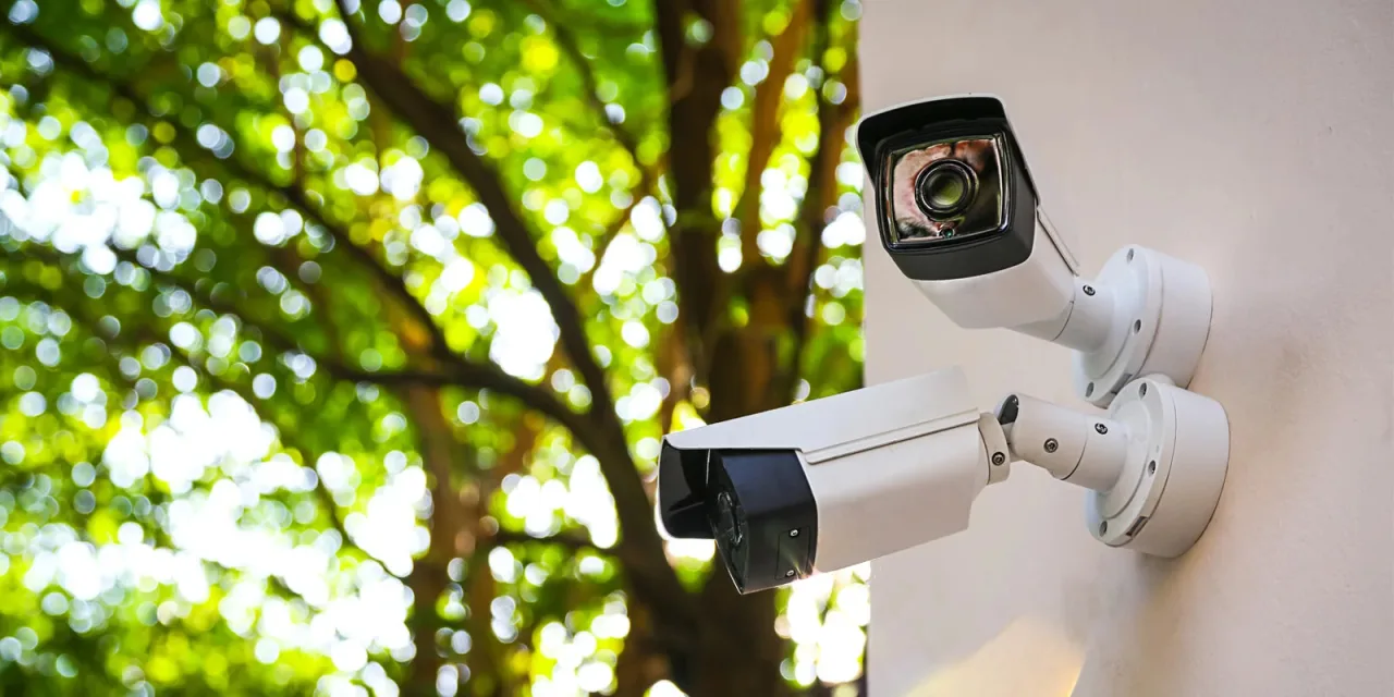 Two exterior security cameras mounted on a building