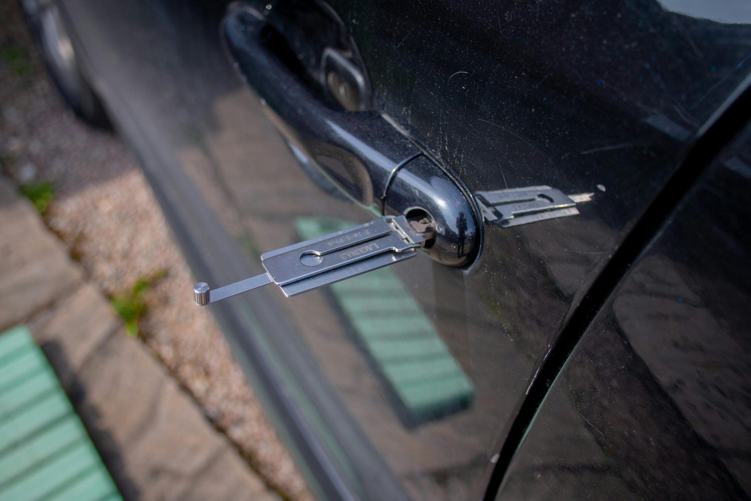 Automotive lock-picking tool inserted into a vehicle door lock