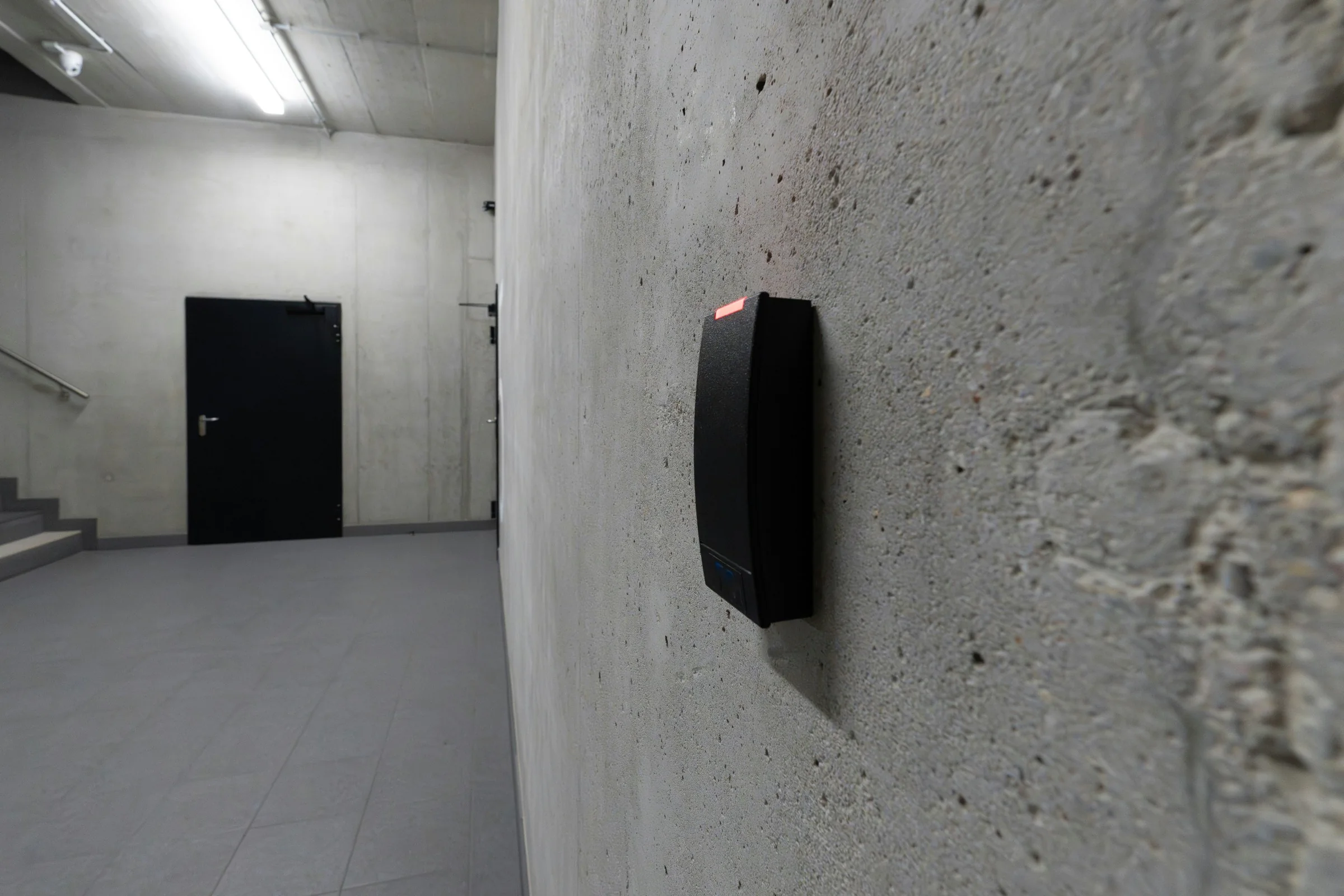 Access reader mounted beside a secured commercial door