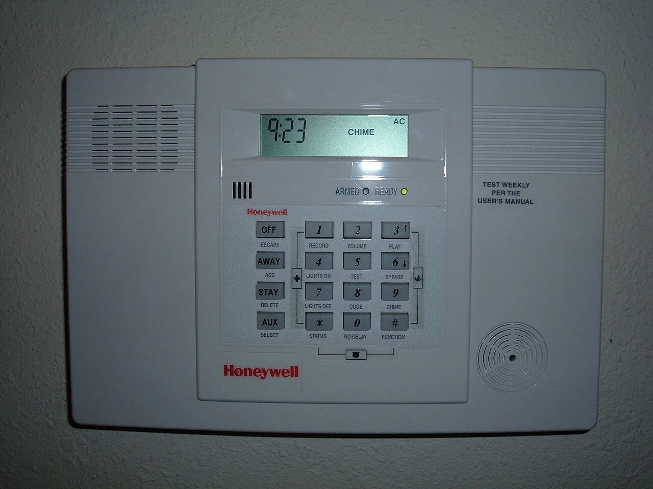 Wall-mounted intrusion-alarm control panel with arming and test controls