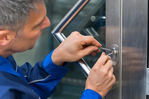 Locksmith restoring access through a commercial entry door