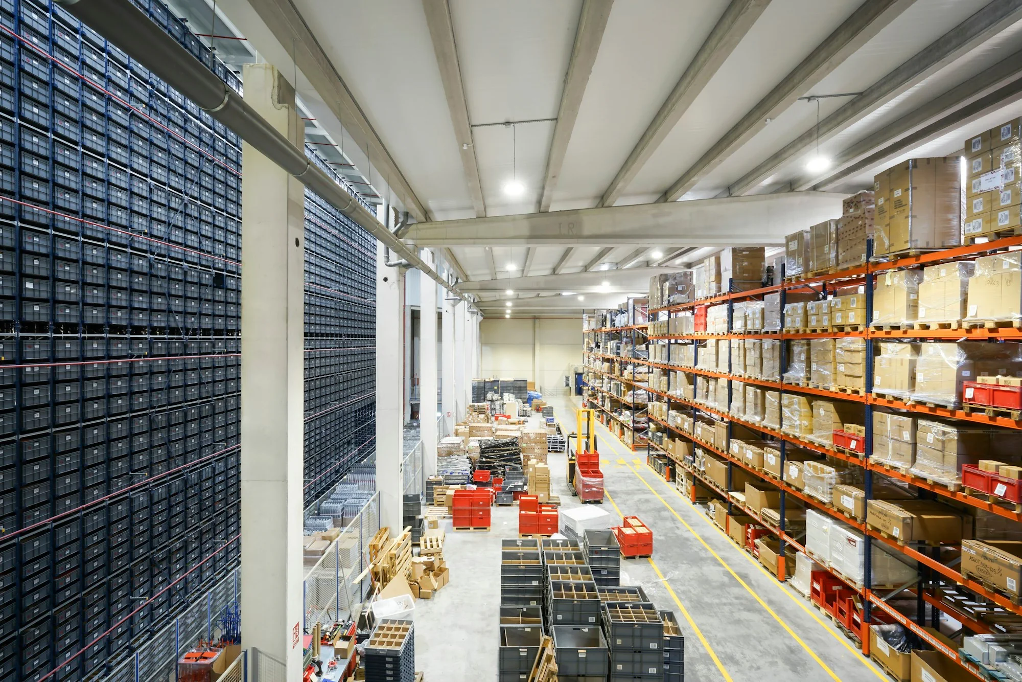 Large commercial warehouse with stocked shelving and open aisles