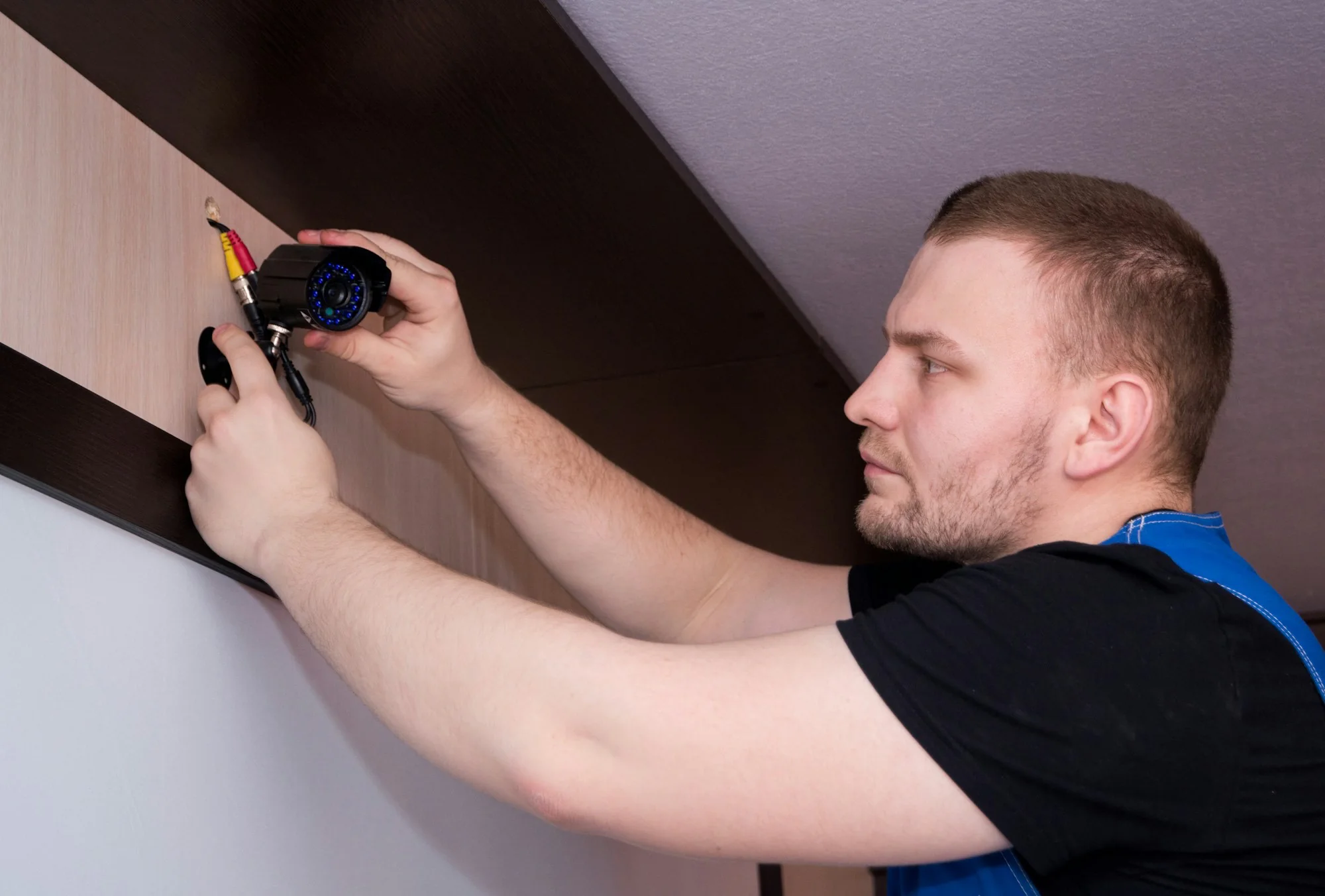 Technician installing and connecting a security camera
