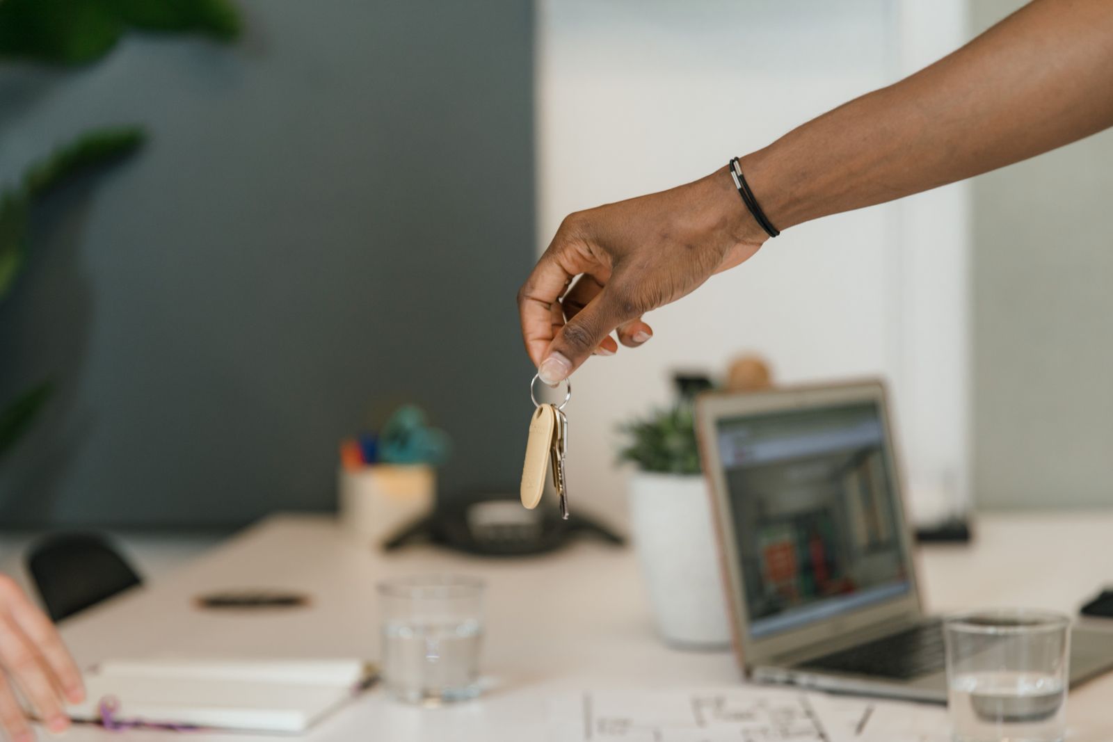 Business keys being handed over at an office desk